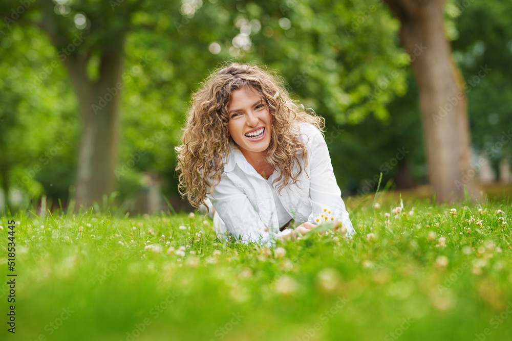 Beautiful woman with curly hair in field with dandelions in her hand. fun in nature. Beautiful woman with curly hair in field with dandelions in her hand. fun in nature.