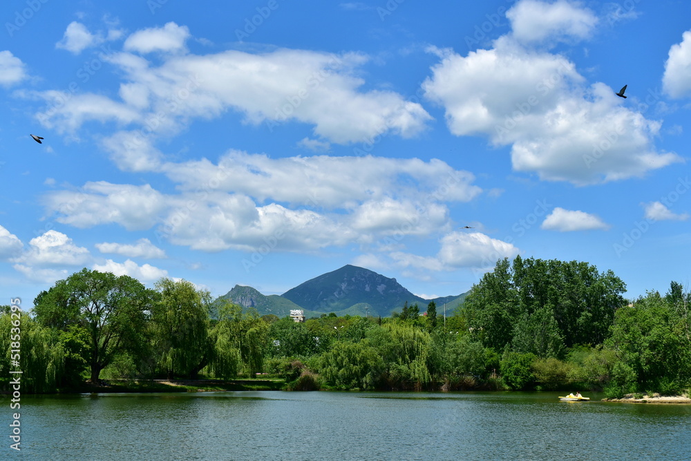 view of Mount Beshtau from the side of the city lake in the park of Pyatigorsk