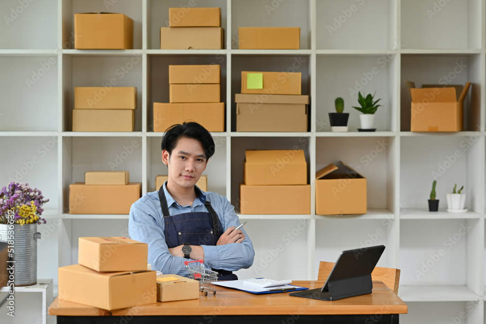 Handsome smart Asian SME business online store owner with stock room as the background, SME startup business. Handsome smart Asian SME business online store owner with stock room as the background, SME startup business.