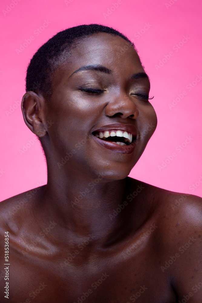 Studio portrait of smiling shirtless woman against pink background Studio portrait of smiling shirtless woman against pink background