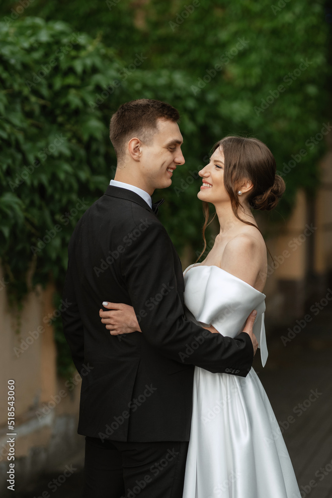 young couple bride and groom in a white short dress young couple bride and groom in a white short dress