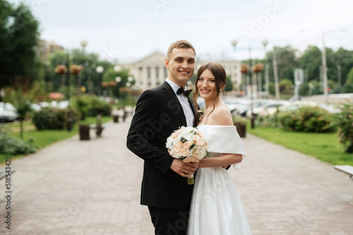 young couple bride and groom in a white short dress