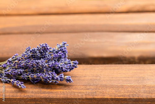 Bouquet of lavender flowers on a wooden background. Place for text. Selective focus.