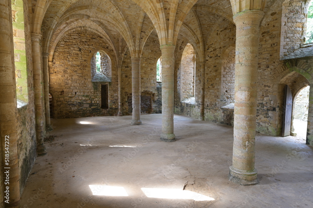 The inside of a Medieval Abbey on a sunlit summer morning.
