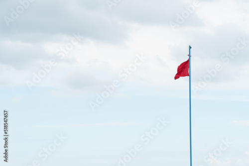 Flag warning beach dangerous red wind blue sky sand day, concept white background from vacation from travel outdoor, weather symbol. Ole cean wimming, idyllic rnli photo