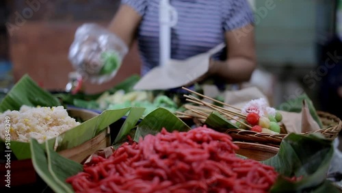 Traders in the market selling traditional snacks, Balinese Indonesian Traditional Snacks, Traditional Cake, Rice Cake in Night Market, Bali, Indonesia, Jajanan Pasar, Jajan Pasar photo