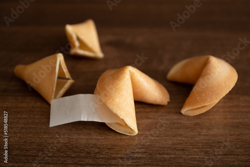 Few fortune cookies with blank paper slip for your wish good luck on table surface