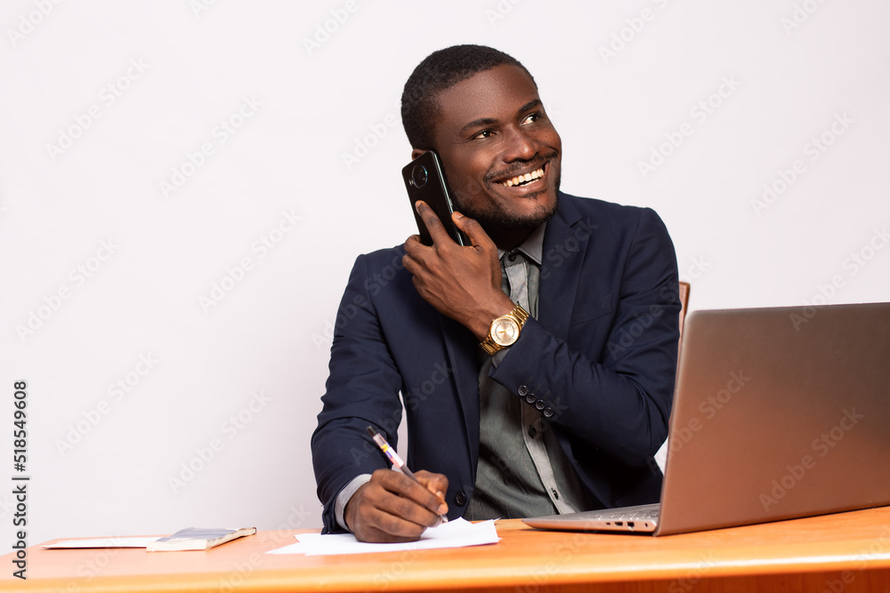african business man making a phone call while working african business man making a phone call while working
