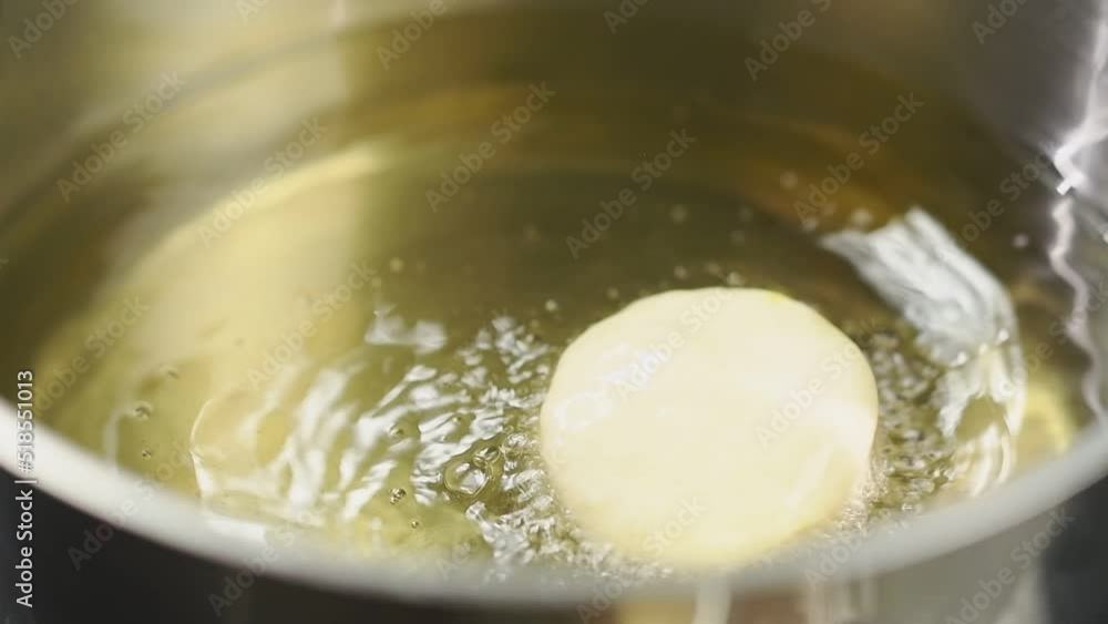 Frying donut in a saucepan.
Frying donut in a saucepan.