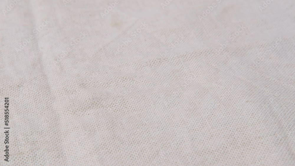 Light fabric of low density with a visible structure rotates, close-up. Light fabric of low density with a visible structure rotates, close-up.