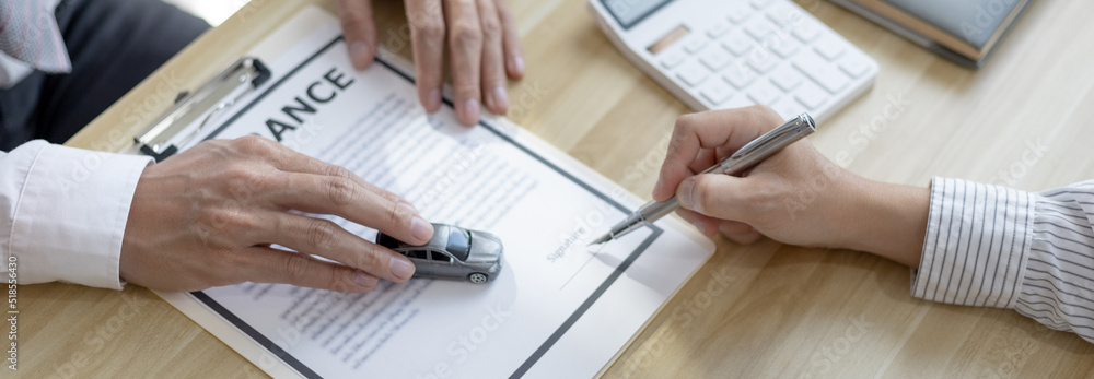 Dealer or manager gives the car to the customers who sign the car purchase documents with insurance, Signing a contract to buy a car that is legal, Document signing and credit approval Concept. Dealer or manager gives the car to the customers who sign the car purchase documents with insurance, Signing a contract to buy a car that is legal, Document signing and credit approval Concept.