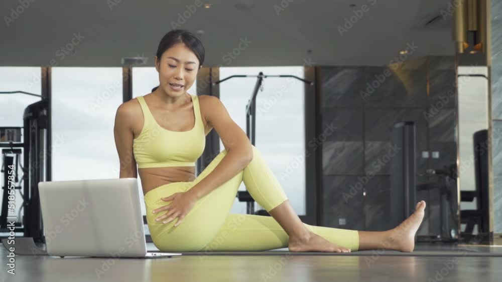 An Asian woman in yoga class club doing exercise and yoga at fitness center or gym. Indoor in sport and recreation concept. People lifestyle activity with urban city view. An Asian woman in yoga class club doing exercise and yoga at fitness center or gym. Indoor in sport and recreation concept. People lifestyle activity with urban city view.