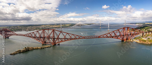 The drone aerial view of  the Forth Bridges and the new Queensferry Crossing. The Forth Bridge is a cantilever railway bridge across the Firth of Forth in the east of Scotland photo