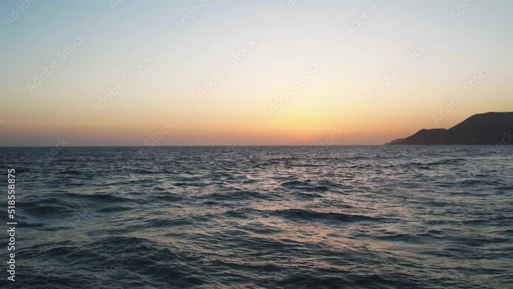 Evening flight over the sea waves after sunset. Drone aerial slow motional video Evening flight over the sea waves after sunset. Drone aerial slow motional video