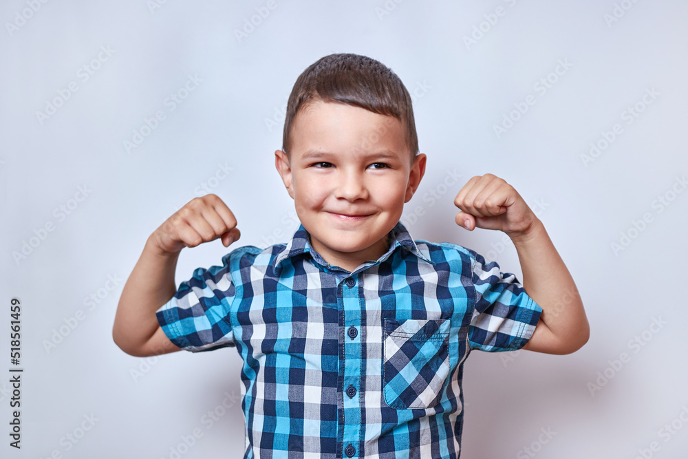 The boy raised his arms and tensed his biceps. Sports and active recreation. The boy raised his arms and tensed his biceps. Sports and active recreation.