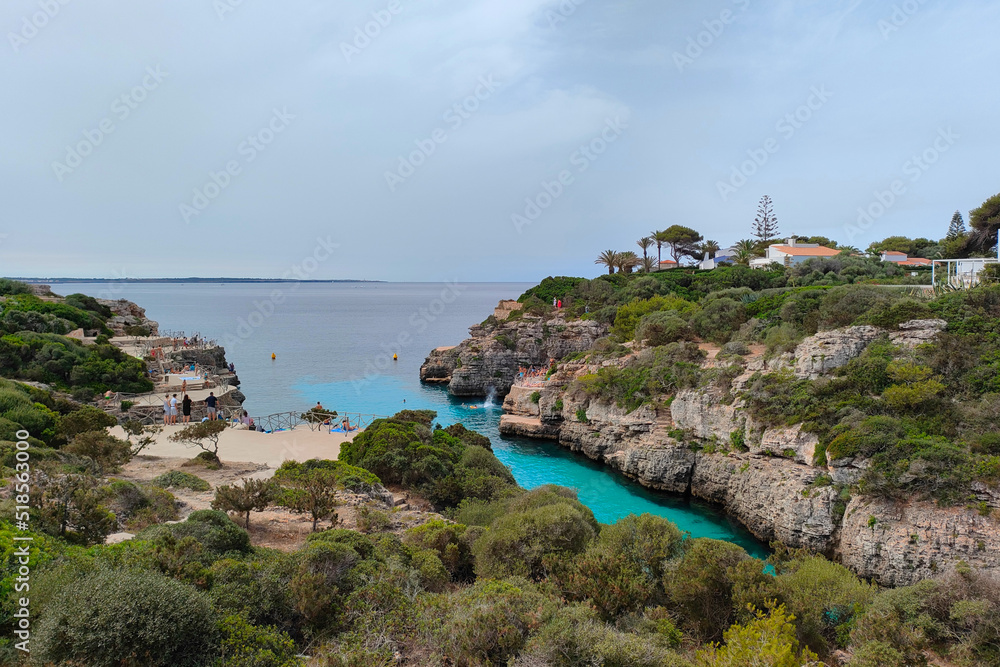Cala en Brut beach, Menorca (Minorca), Spain. Lovely bay and beach Cala'n Brut. Popular place to jump into water from rock shelves