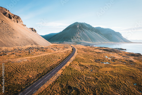 Quadro em tela Scenic asphalt road with mountain and golden field on coastline in summer at Ice
