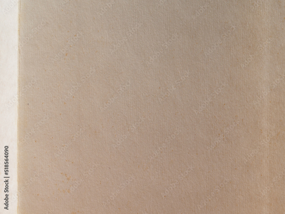 The texture of old yellowed paper. Brown textured background made of kraft paper. Paper background The texture of old yellowed paper. Brown textured background made of kraft paper. Paper background
