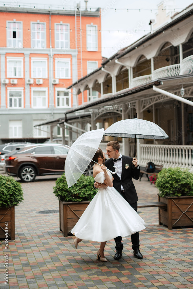 Obraz premium young couple bride and groom in a white short dress