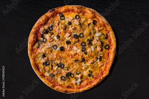 Pizza with olives, salmon, squid, mussels, cheese