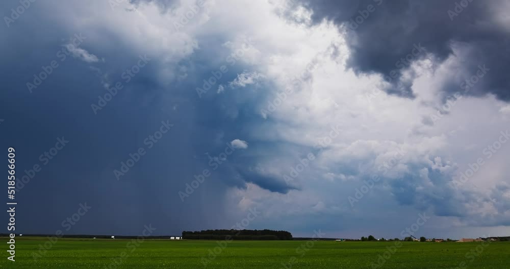 Storm clouds over field, Light precipitation supercell, extreme weather, dangerous storm Storm clouds over field, Light precipitation supercell, extreme weather, dangerous storm