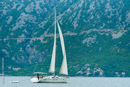 Sails yacht against the backdrop of mountains in Balkans