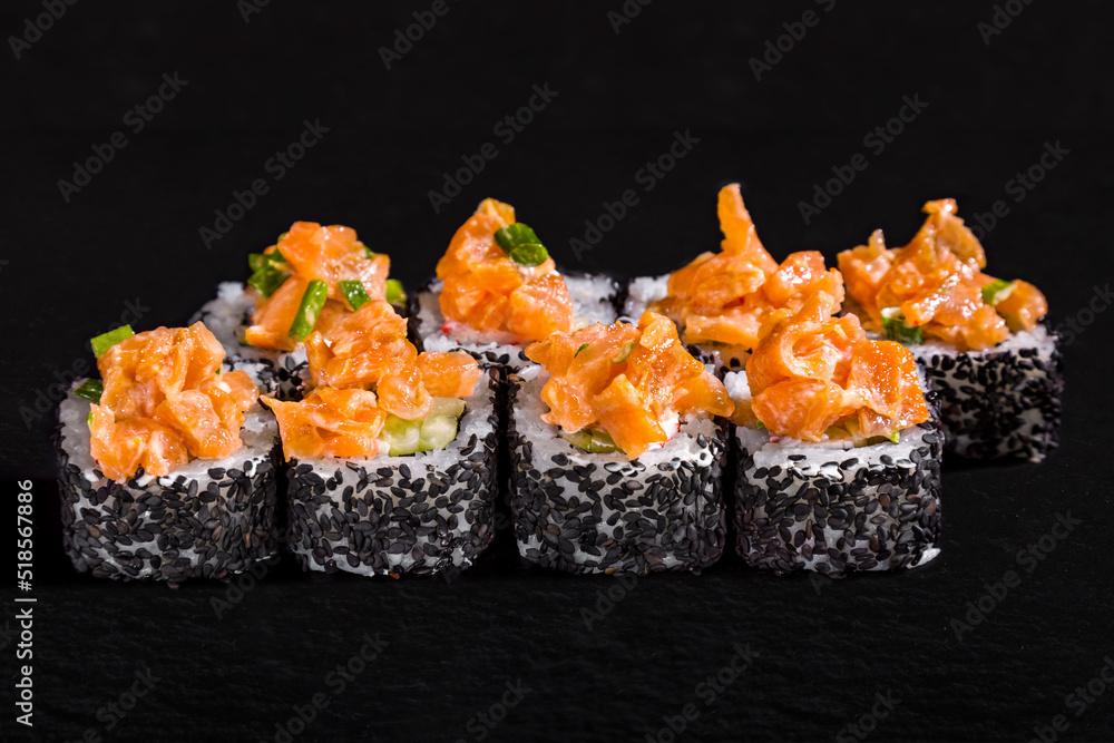 Rolls with sesame seeds, rice, salmon, onion and cucumber Rolls with sesame seeds, rice, salmon, onion and cucumber