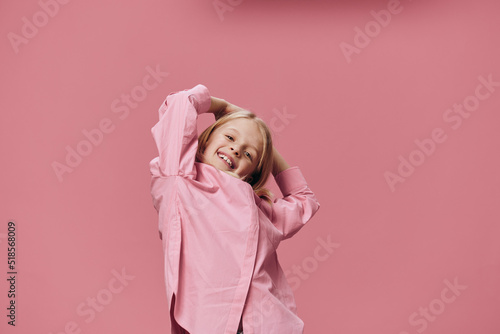 cute beautiful girl in pink clothes funny posing leaning back