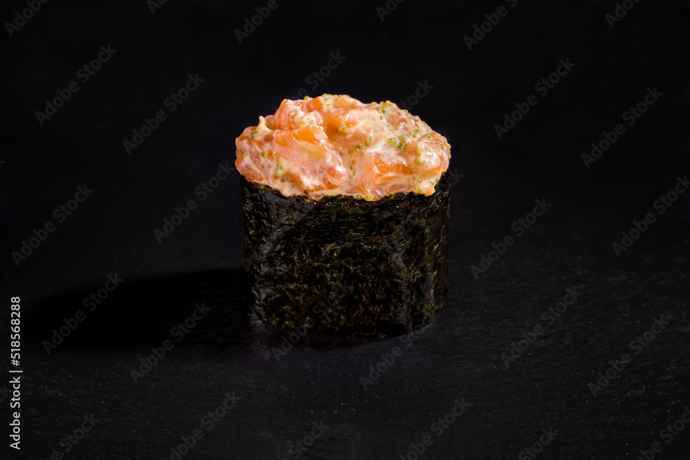 Roll with seafood with tobiko caviar, sauce and nori Roll with seafood with tobiko caviar, sauce and nori