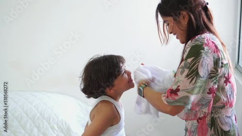Mother getting her child dressed for school