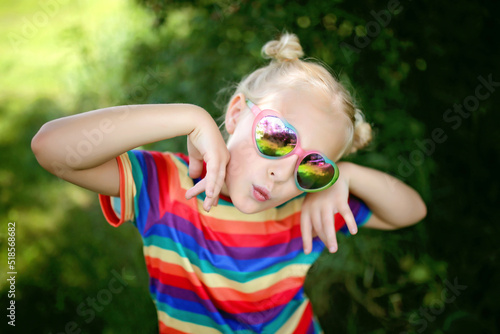 Cute Little Girl Making Silly Fish Face in Sunglasses photo