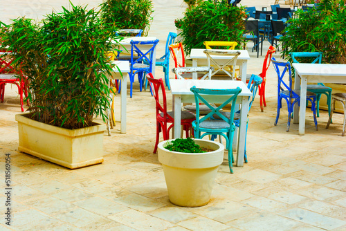 Table and chair setup in Italian terrace restaurant in Marzamemi province of Syracuse – Patio in Marzamemi fishing village photo