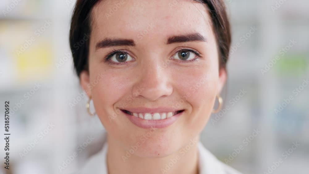 Elegant woman laughing with grey eyes wide open and a toothy grin. Face of young pretty professional looking up from her work and smiling at the camera with blurred office in the background Elegant woman laughing with grey eyes wide open and a toothy grin. Face of young pretty professional looking up from her work and smiling at the camera with blurred office in the background