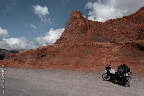Motorcycle with luggage on mountain road in Himalayas in red canyon moyntains