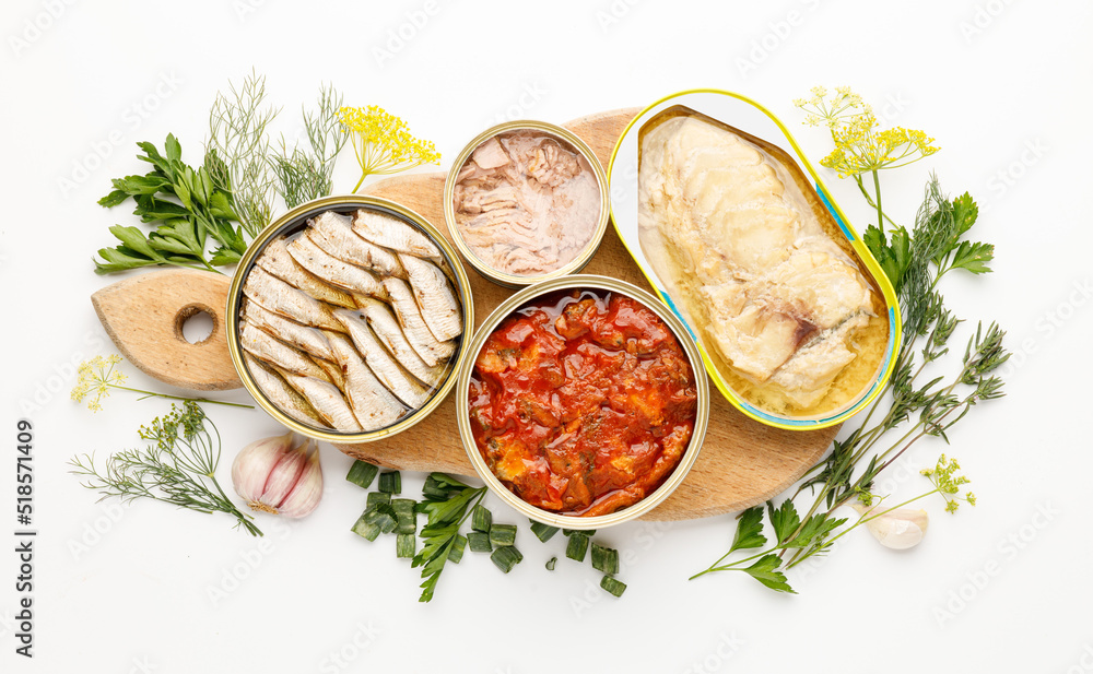Processed fish in tins on a white background. Canned food. Processed fish in tins on a white background. Canned food.