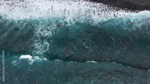 Wallpaper Mural 4K drone slowly flying over ocean coast with white waves rolling and foaming, stones on bottom clearly shown through transparent water. Environment, elements, rough waters concept. Torontodigital.ca