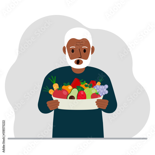 A man with a large plate of healthy organic food - vegetables and fruits. The concept of healthy food, healthy lifestyle, vegetarianism, agriculture.