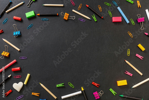 Back to school background. School office supply and stationery flat lay on black, top view