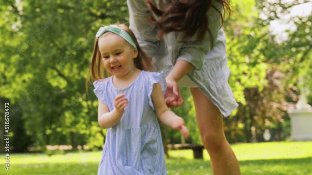 family, motherhood and people concept - happy mother with little daughter playing at summer park or garden family, motherhood and people concept - happy mother with little daughter playing at summer park or garden
