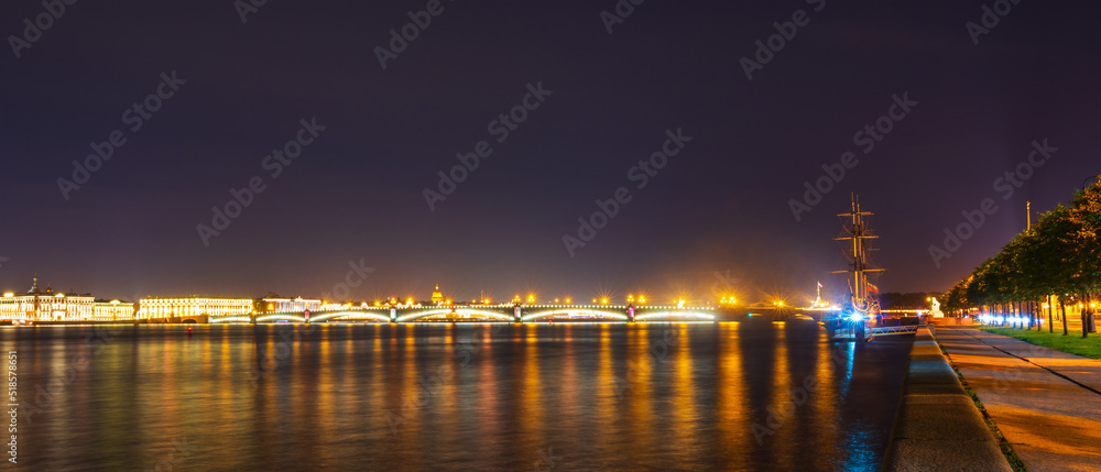 Night panorama of the Neva River and St. Petersburg, Russia. View of the Fregat Blagodat and the Trinity Bridge