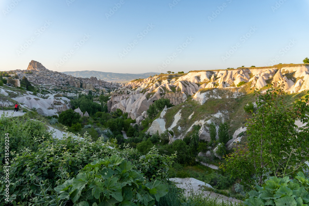Panorama of Pigeon Valley in Cappadocia, with the sunset light, with the Ushisar castle in the background of the photo.