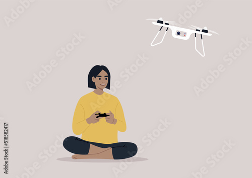 Tela A young female character flying a drone with a remote control, new technologies