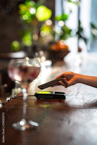 paying with smartphone at a bar