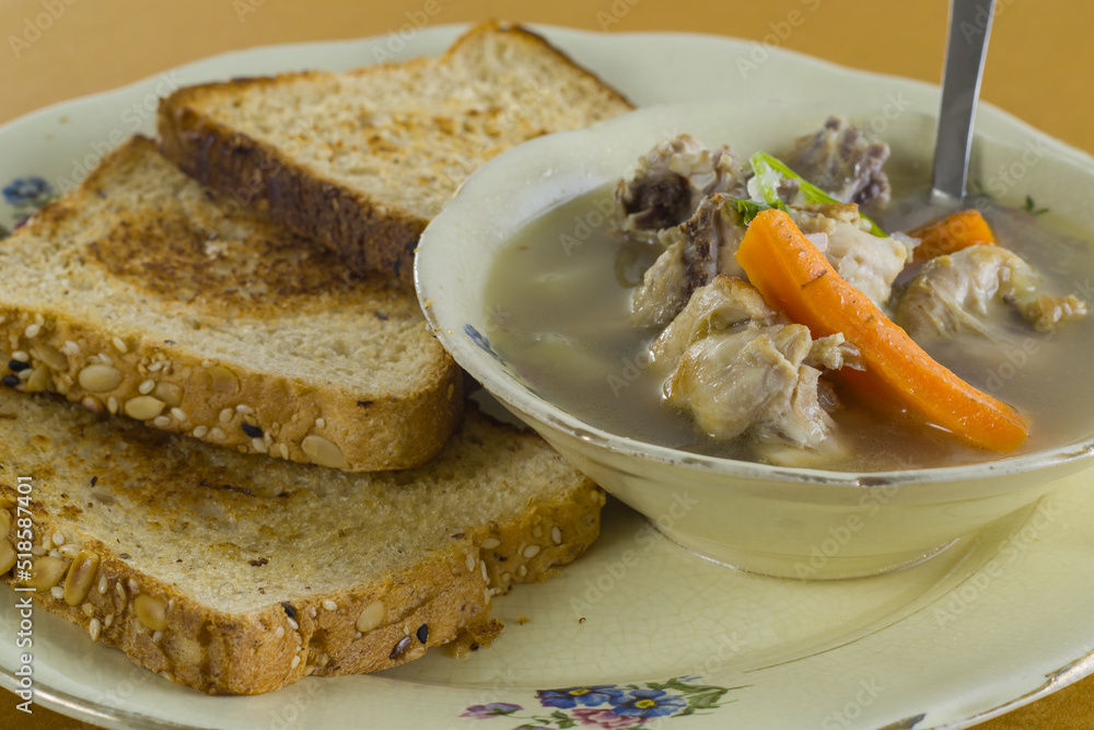 chicken stew with multi grain brown bread served on a plate as breakfast. healthy soup with vegetables. chicken stew with multi grain brown bread served on a plate as breakfast. healthy soup with vegetables.