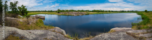 Fototapeta Naklejka Na Ścianę i Meble -  Peaceful wildlife animal sanctuary and glacial rock pond landscape at Big Stone National Wildlife Refuge in Minnesota River, Odessa, Minnesota