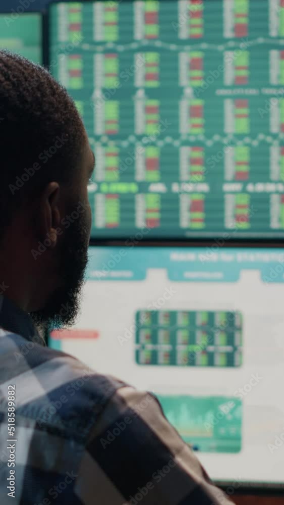 Vertical video: Hedge fund trader monitoring stock trade exchange on graphs and charts. Analyzing forex market statistics, capital sales and financial profit for business investment. Handheld shot. Vertical video: Hedge fund trader monitoring stock trade exchange on graphs and charts. Analyzing forex market statistics, capital sales and financial profit for business investment. Handheld shot.