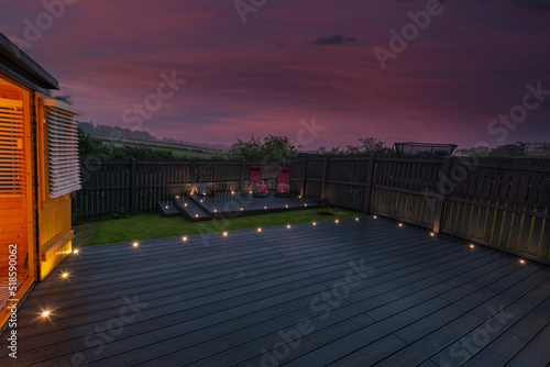 New Laid Composite Decking Ash Colour and with Decking Lights Installed. Lights are Illuminated