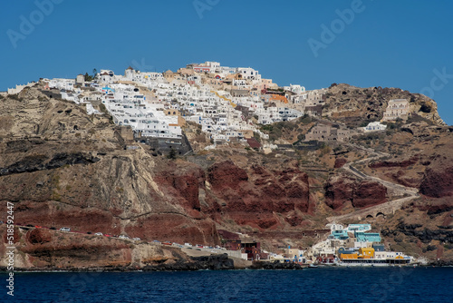 View of the picturesque village of Oia and the the famous Ammoudi harbour in Santorini Greece