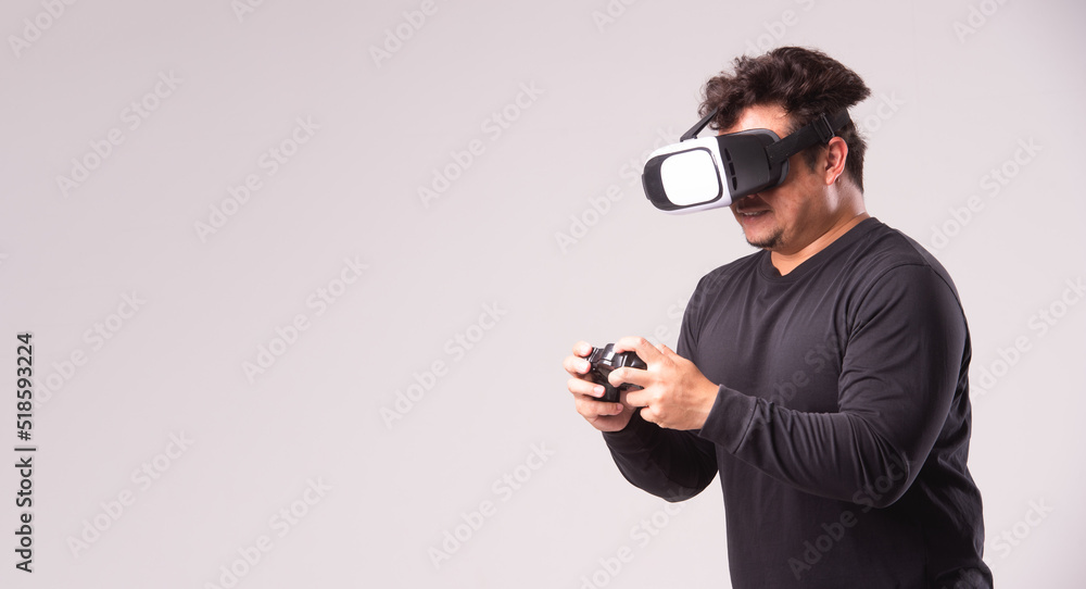 Young asian man using virtual reality headset. VR, future, gadgets, technology concept Young asian man using virtual reality headset. VR, future, gadgets, technology concept