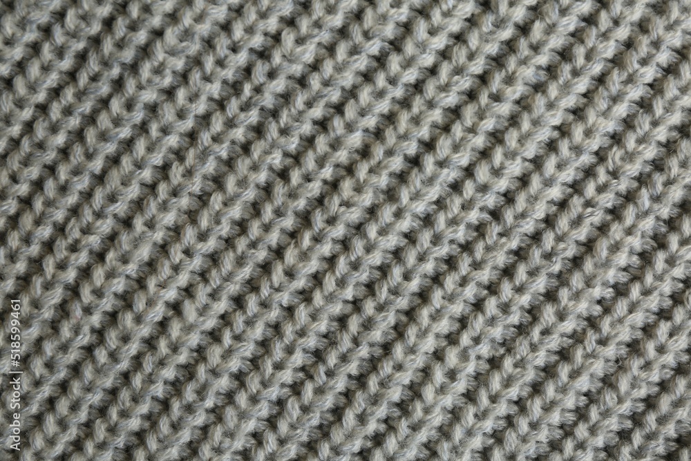 Beautiful grey knitted fabric as background, top view Beautiful grey knitted fabric as background, top view
